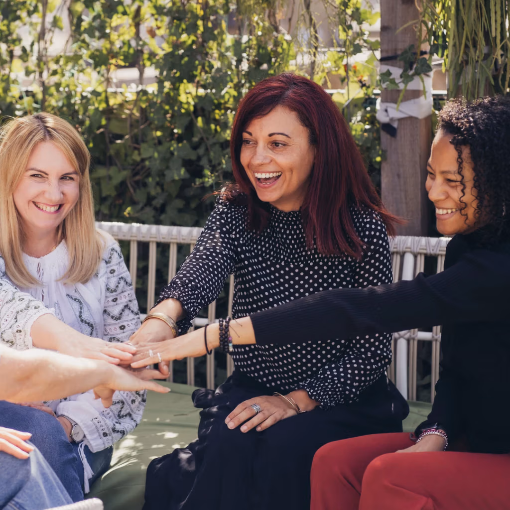 Social media posts - group of friends with hands meeting in the middle of the group